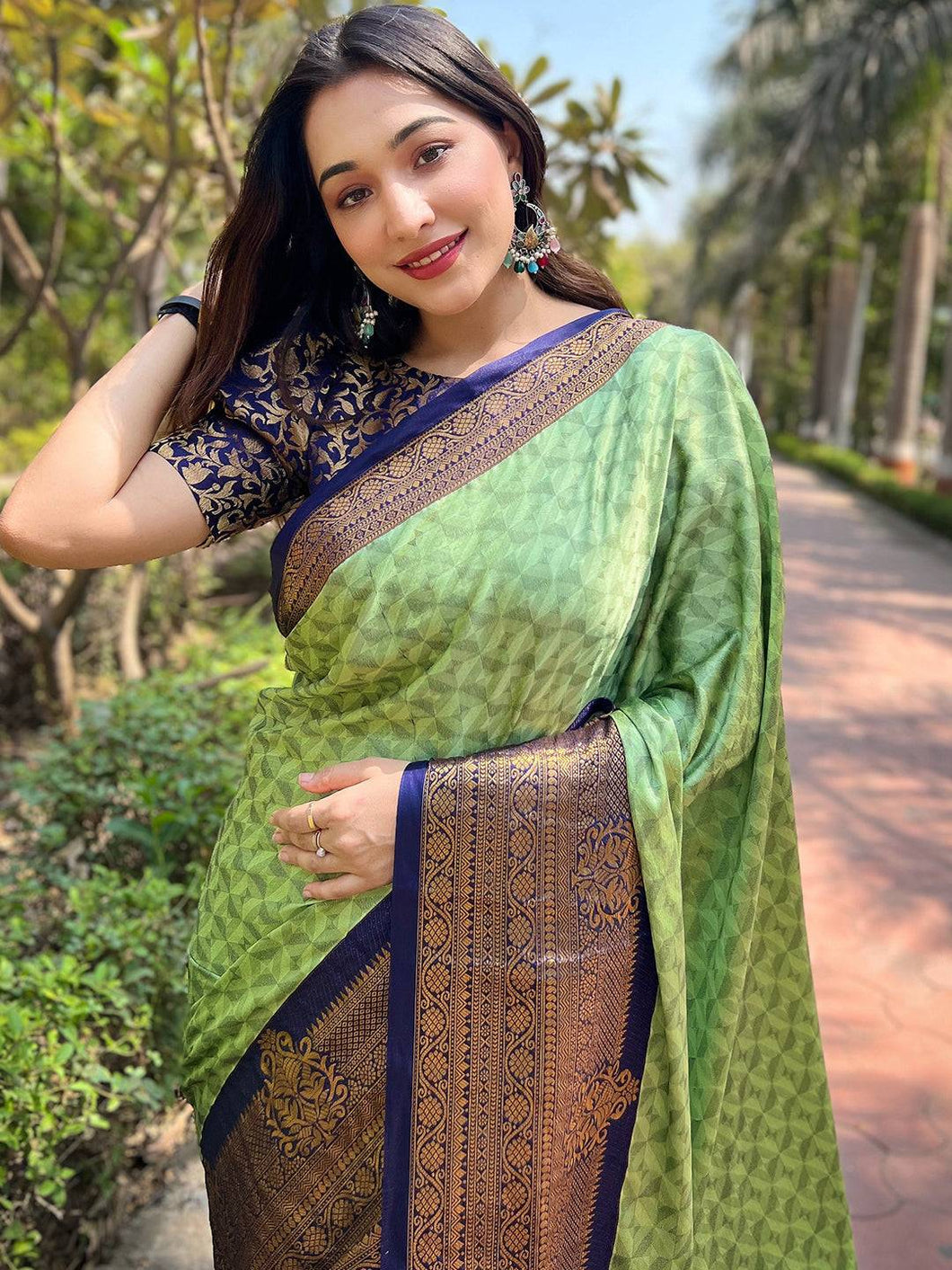 Woman in green Kanjivaram silk saree with brocade blouse