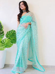 Elegant net saree with sequins embroidery, worn by model