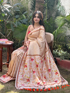 Peach Banarasi Kanjivaram floral saree draped elegantly outdoors