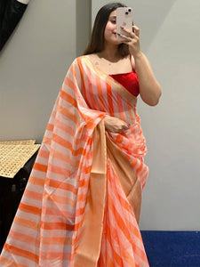 Soft organza leheriya saree with digital print in orange and cream.