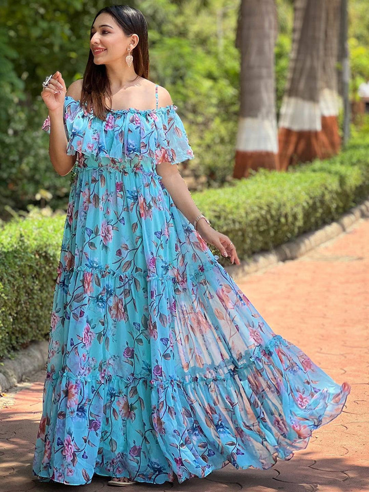 Woman in blue floral maxi dress walking outdoors