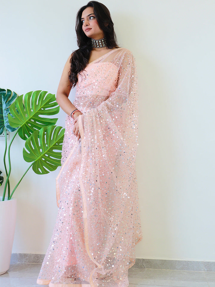 Beautiful net saree with sequins embroidery, worn by model.